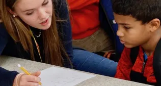 After School Mentor helping boy with homework