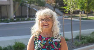 Judi in glasses smiling