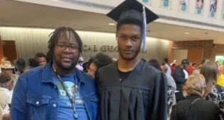 two men at a high school grauation