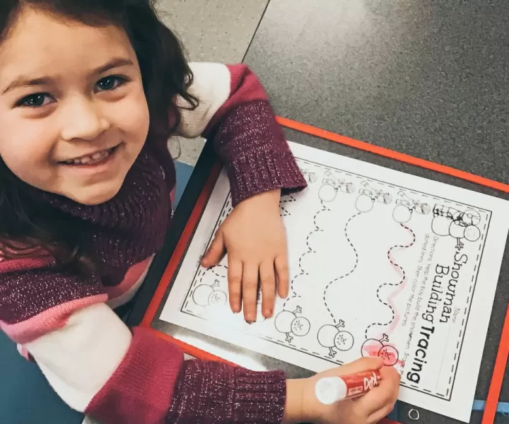 cute little girl with worksheet