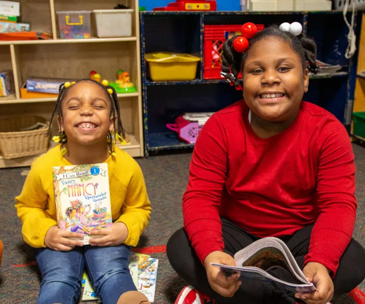 Two girls reading books